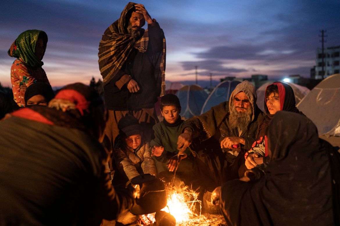 A family warms up next to a makeshift fire in Herat, Afghanistan