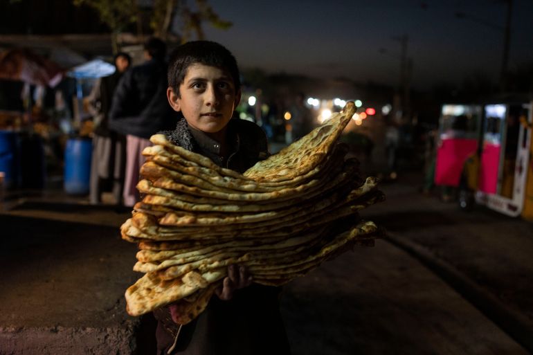 A boy carries bread in Herat, Afghanistan