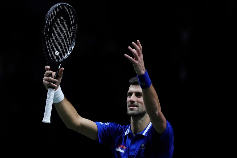 Novak Djokovic is seen raising his arm and tennis racket after defeating Croatia's Marin Cilic in Madrid, Spain
