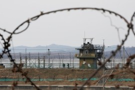 South Korean soldiers, seen through barbed wire, on patrol in Paju near the border with North Korea