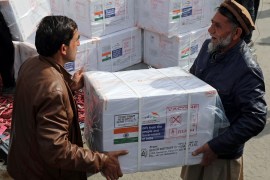 Afghan health ministry workers unloads boxes of the first shipment of 500,000 doses of the AstraZeneca coronavirus vaccine