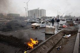 A torched car is seen on a street in Almaty, Kazakhstan