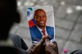 Person holding picture of assassinated Haitian President Jovenel Moise