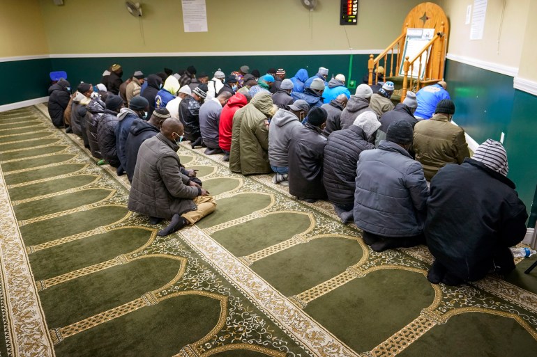 People pray at a mosque in the Bronx, near where an apartment fire killed 17