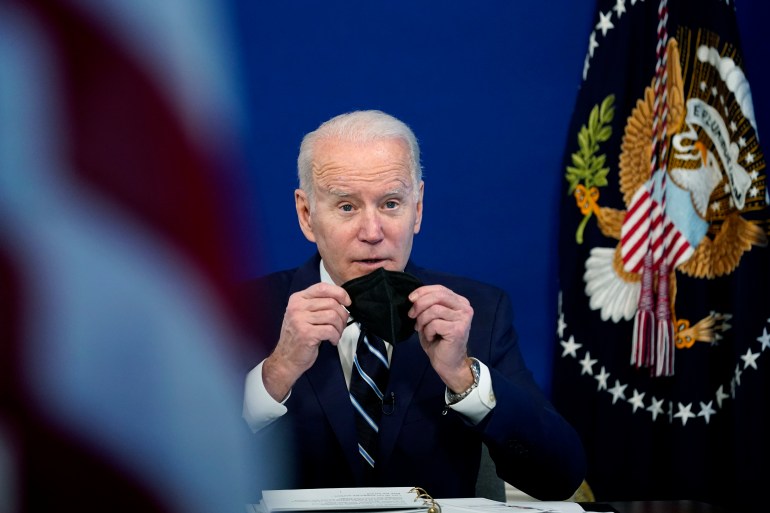 US President Joe Biden removing mask ahead of speech