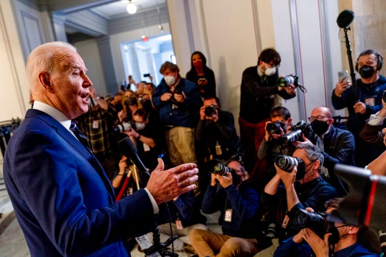 President Joe Biden speaks to members of the media as he leaves a meeting with the Senate Democratic Caucus to discuss voting rights.