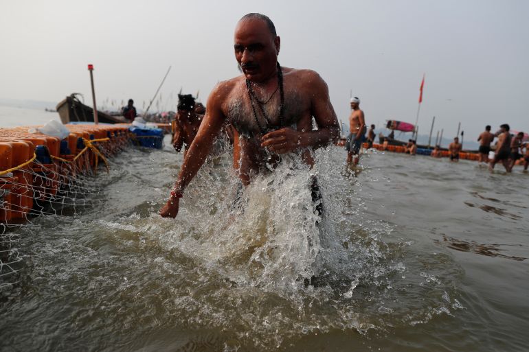 A Hindu devotee takes a ritualistic bath in the Sangam in Prayagraj, India