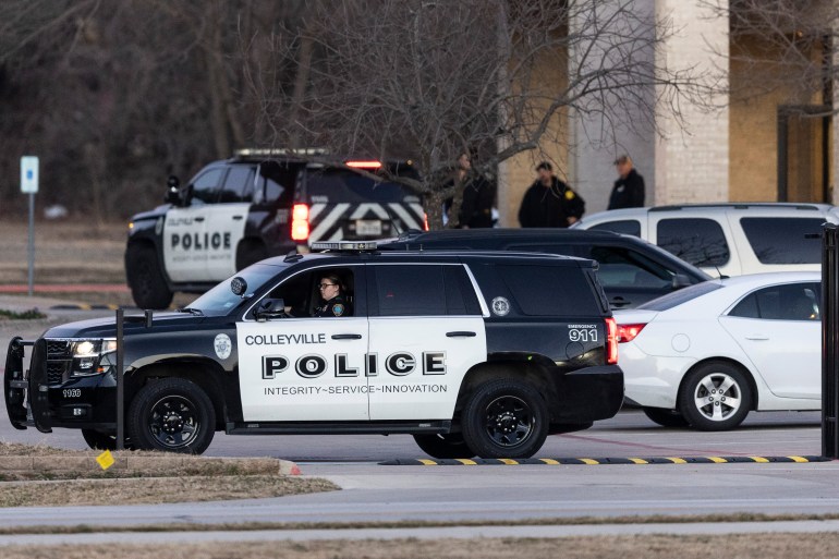 Police stage in front of the Congregation Beth Israel synagogue, Sunday, Jan. 16, 2022, in Colleyville, Texas.