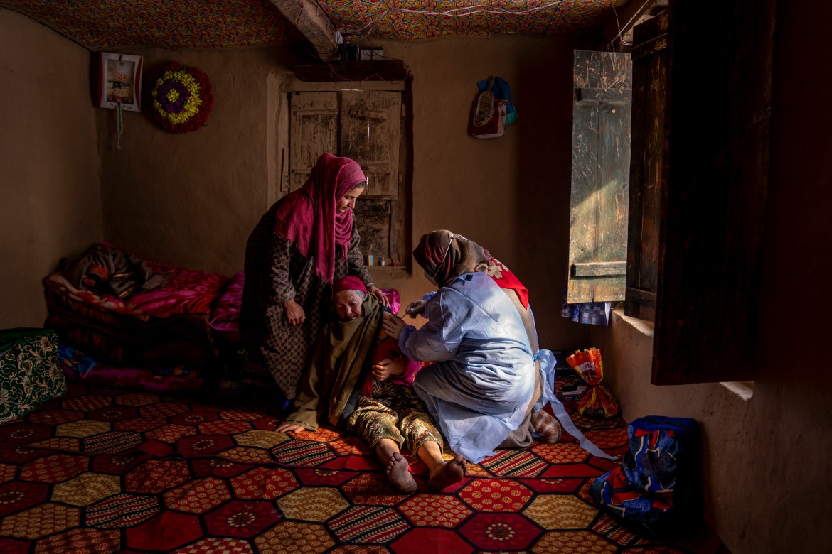 An elderly Kashmiri woman receives the Covishield vaccine for COVID-19 in Indian controlled Kashmir