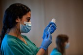 A medical staff member prepares a dose of the Moderna COVID-19 vaccine, at San Pedro Hospital in Spain [File: Alvaro Barrientos/AP Photo]