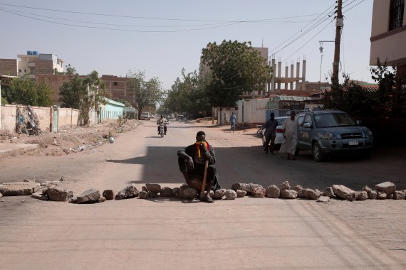 People set up a barricade on an empty street as part of a civil disobedience campaign in Khartoum, Sudan