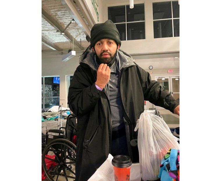 Malik Faisal Akram, dressed in a winter coat and hat, is seen at a Dallas homeless shelter. 