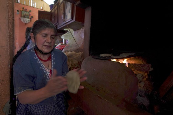 A woman makes tortillas in the Puerpecha Indigenous community of Comachuen, Mexico
