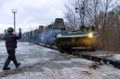 In this photo taken from video provided by the Russian Defense Ministry Press Service, a Russian armoured vehicle drives off a railway platform after arrival in Belarus on Wednesday [File: Russian Defense Ministry/AP]