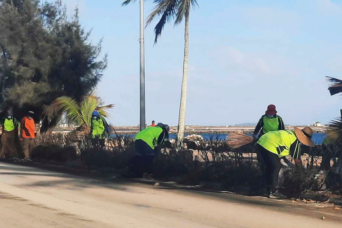 People clear debris off the street in Nuku'alofa, Tonga