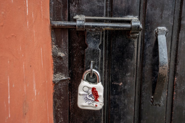 A sealed lock hangs on the door of the closed Kashmir Press Club