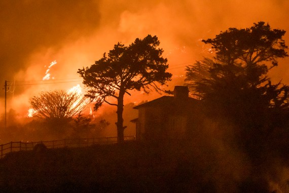 The Colorado Fire burns behind a house off Highway 1 near Big Sur