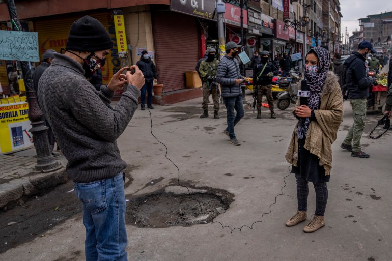 Kashmiri Journalists work during surprise search of pedestrians