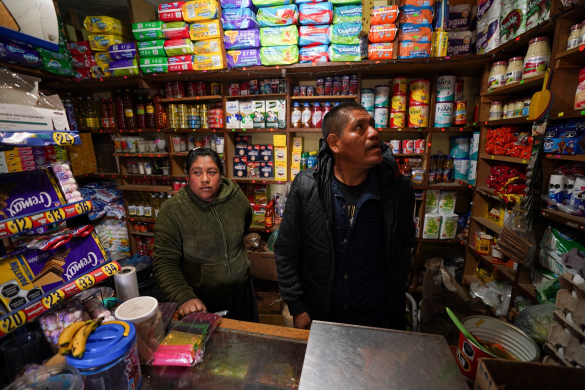 Jose Gonzalez and his wife Maria, wait for customers in their corner shop that he remodeled