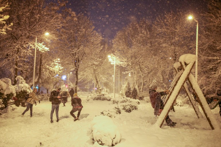 People throw snowballs each other on the snow-covered park in Istanbul