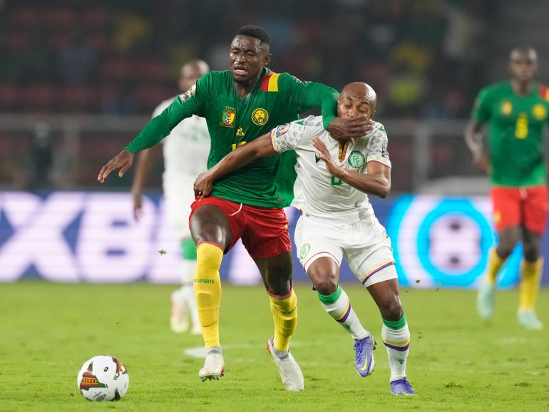 Comoros' Fouad Bachirou, right, is challenged by Cameroon's Martin Hongla during the African Cup of Nations