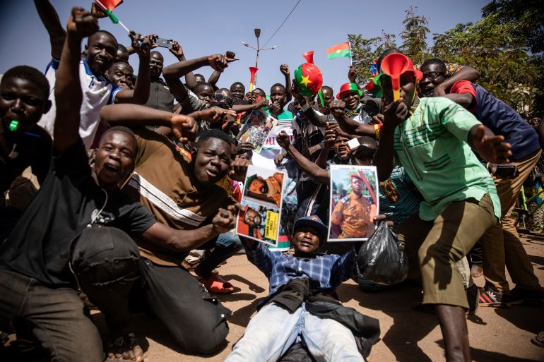 People celebrate in the streets of Ouagadougou, Burkina Faso to rally in support of the new military junta