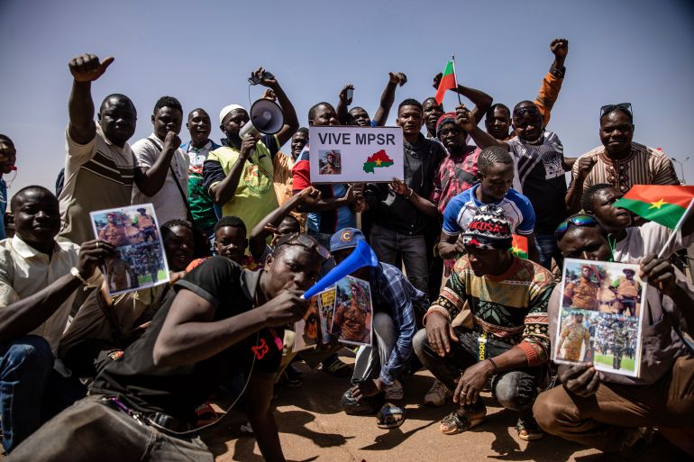 People take to the streets of Ouagadougou, Burkina Faso, Tuesday Jan. 25, 2022 to rally in support of the new military junta that ousted democratically elected President Roch Marc Christian Kabore and seized control of the country.