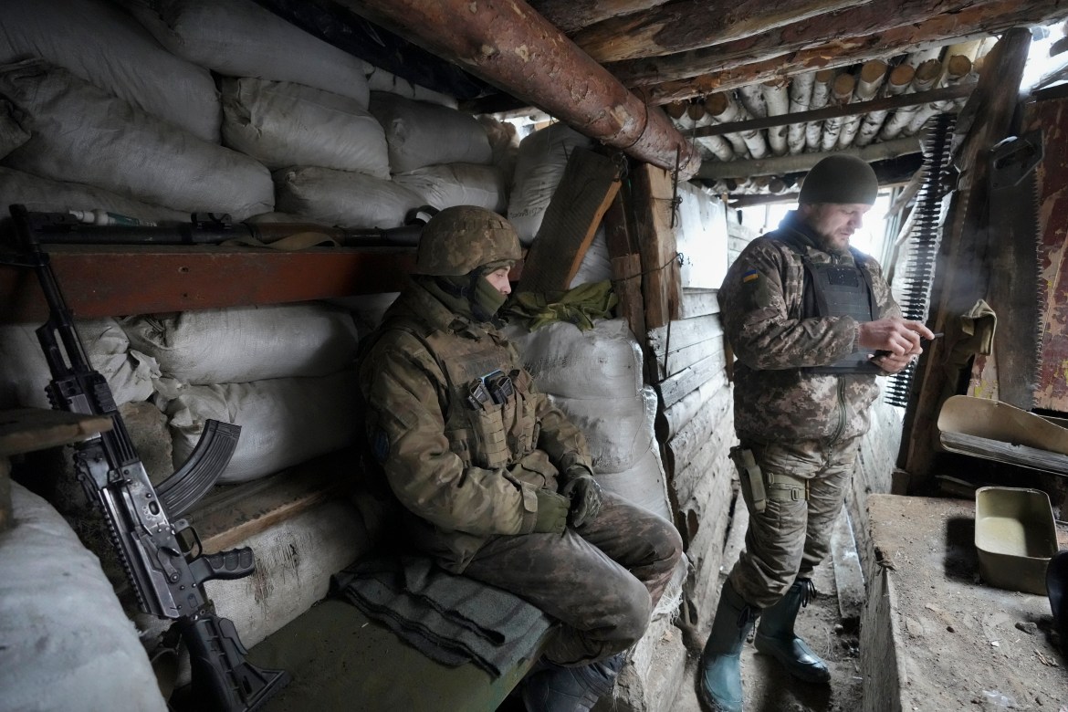 Ukrainian servicemen rest in a shelter on the front line in the Luhansk region, eastern Ukraine, Friday, Jan. 28, 2022.