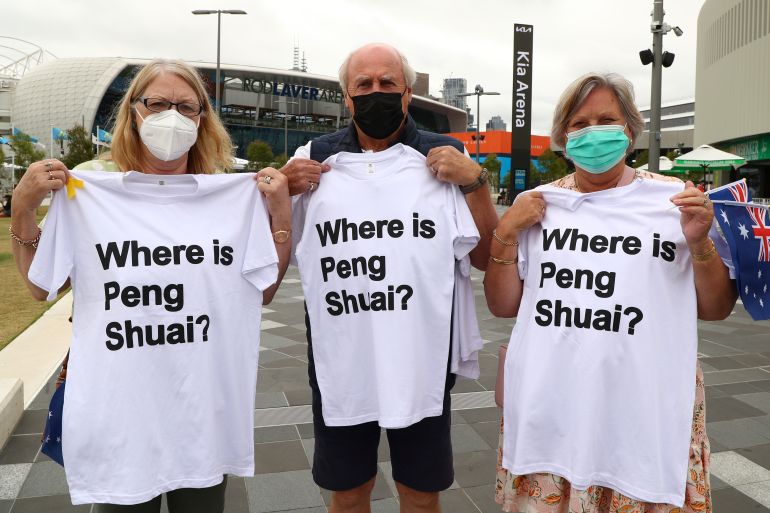 Supporters of Chinese tennis player Peng Shuai hold up their T-shirts