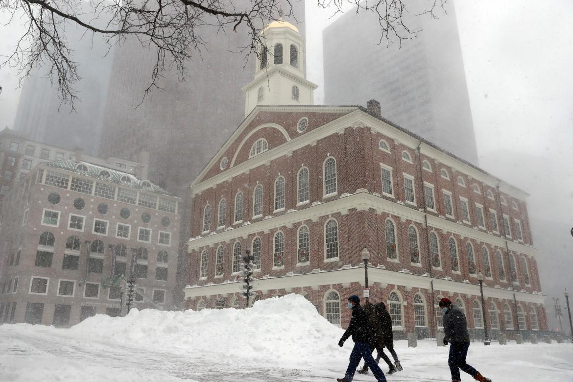 People walk in the snow outside Faneuil Hall,