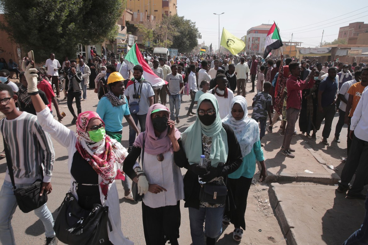 People chant slogans during a anti-coup protests that have rocked the country since a military coup three months ago.in Khartoum, Sudan, Sunday, Jan. 30, 2022.