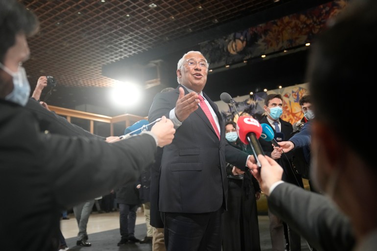 Portuguese Prime Minister and Socialist Party Leader Antonio Costa in dark suit, white shirt and red tie, speaks to journalists as his party secured a third election victory.