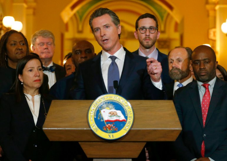 California Governor Gavin Newsom discusses his decision to place a moratorium on the death penalty during a news conference at the Capitol, in Sacramento, California.