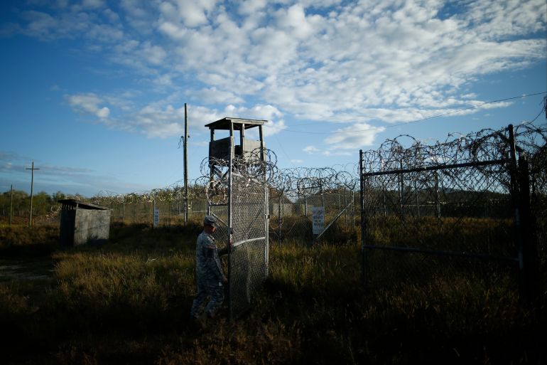 A US soldier closes the gate at Guantanamo Bay Naval Base, Cub