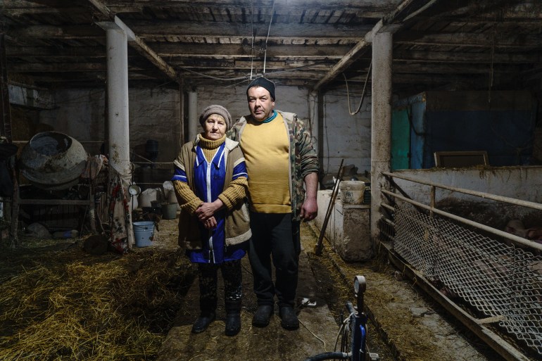 Valentina Omelnycka, 63, and Andriy Dmytryuchenko, 45, in their friend's barn near Pisky, Ukraine
