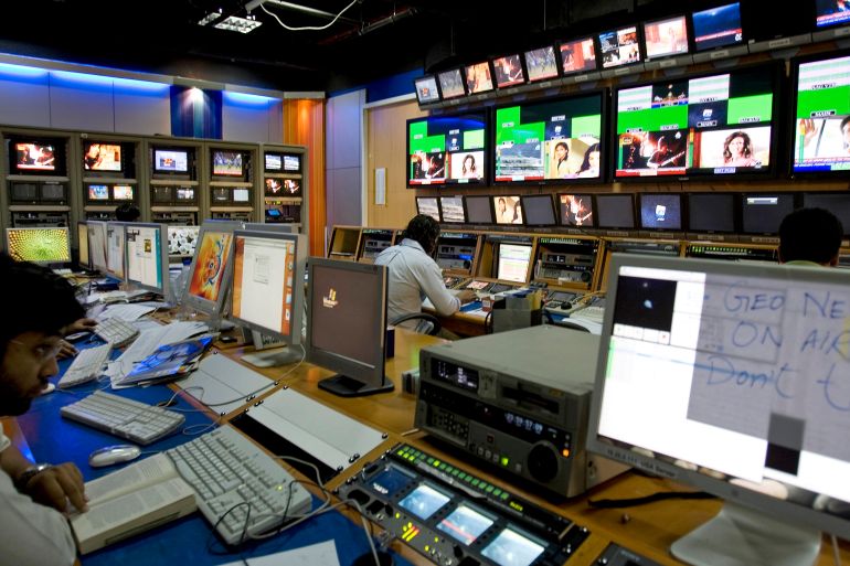 TV producers work at a control room of Geo News