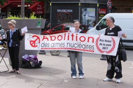 Activists holding a banner that reads "abolition" are seen during protest against nuclear weapons