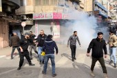 Palestinian Authority security forces firing tear gas at mourners during the funeral of Jamil Kayyal who was killed by Israeli forces in Nablus on December 13, 2021 [Al Jazeera]