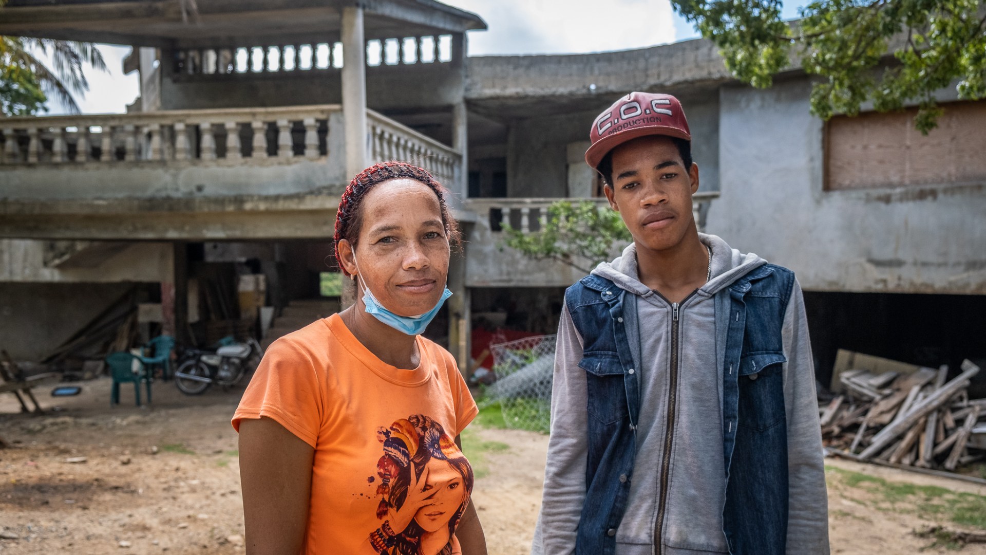 Engrid Rodriquez, a Dominican woman, stands with one of her sons
