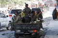 Somali military supporting Prime Minister Mohamed Hussein Roble ride on their pick-up trucks
