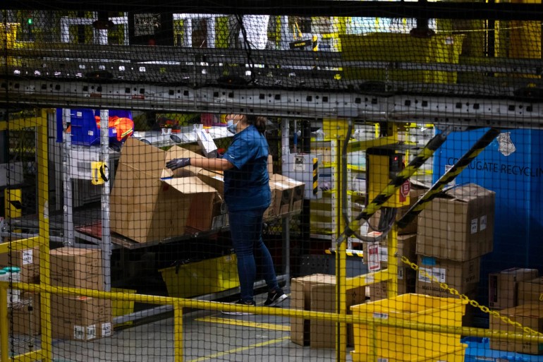 A worker sorts merchandise at an Amazon fulfillment center on Cyber Monday in Robbinsville, New Jersey, U.S.