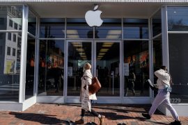 Pedestrians walk past an Apple store as Apple Inc. reports fourth quarter earnings in Washington, US