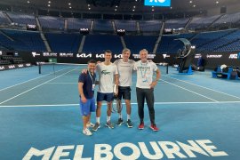 Novak Djokovis stands on a tennis court