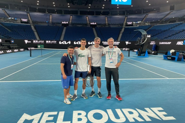 Novak Djokovis stands on a tennis court