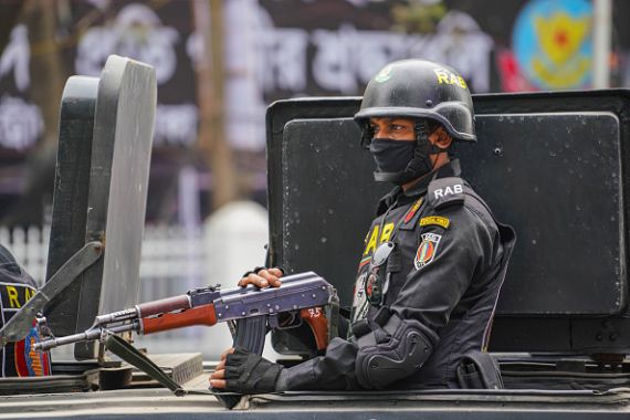 A Rapid Action Battalion official is seen in front of Central Shaheed Minar in the capital Dhaka.