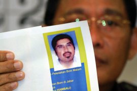 Indonesia's top detective holds a photo of Hambali at a press conference in 2003