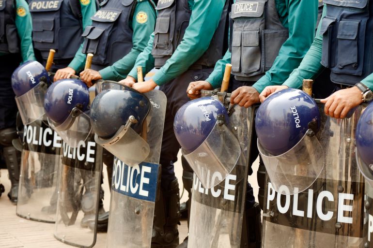 Police officers stand guard in front of Baitul Mukarram mosque in Dhaka
