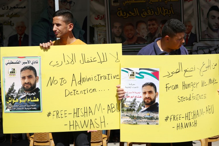 Relatives of hunger-striking Palestinian prisoner Hisham Abu Hawash rally in Hebron