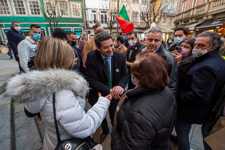 Leader of Portugal's Chega party shaking hands with supporters