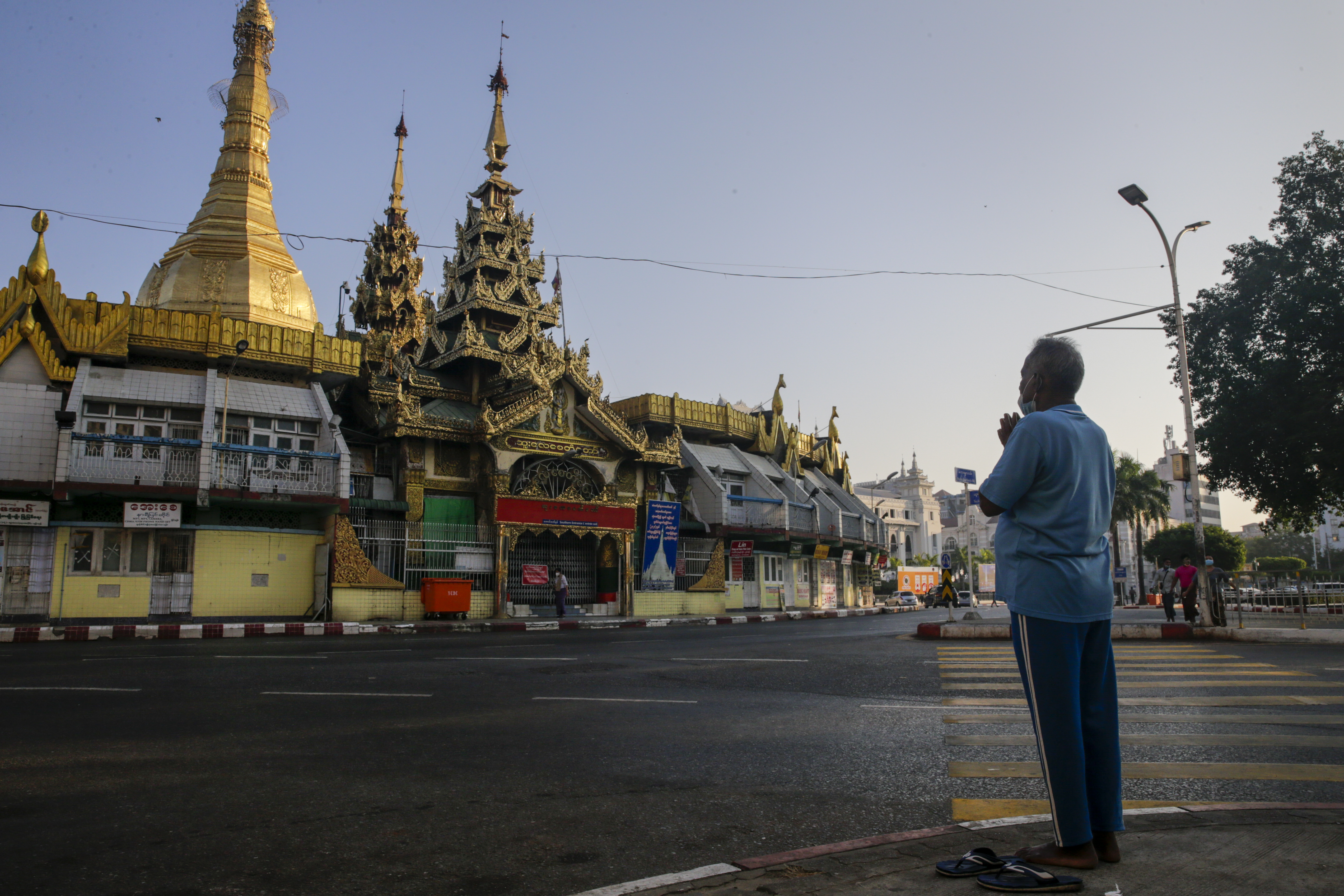 A man prays outside Yangon